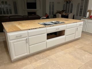 Mike’s completed kitchen island with fitted cabinetry and a stone countertop